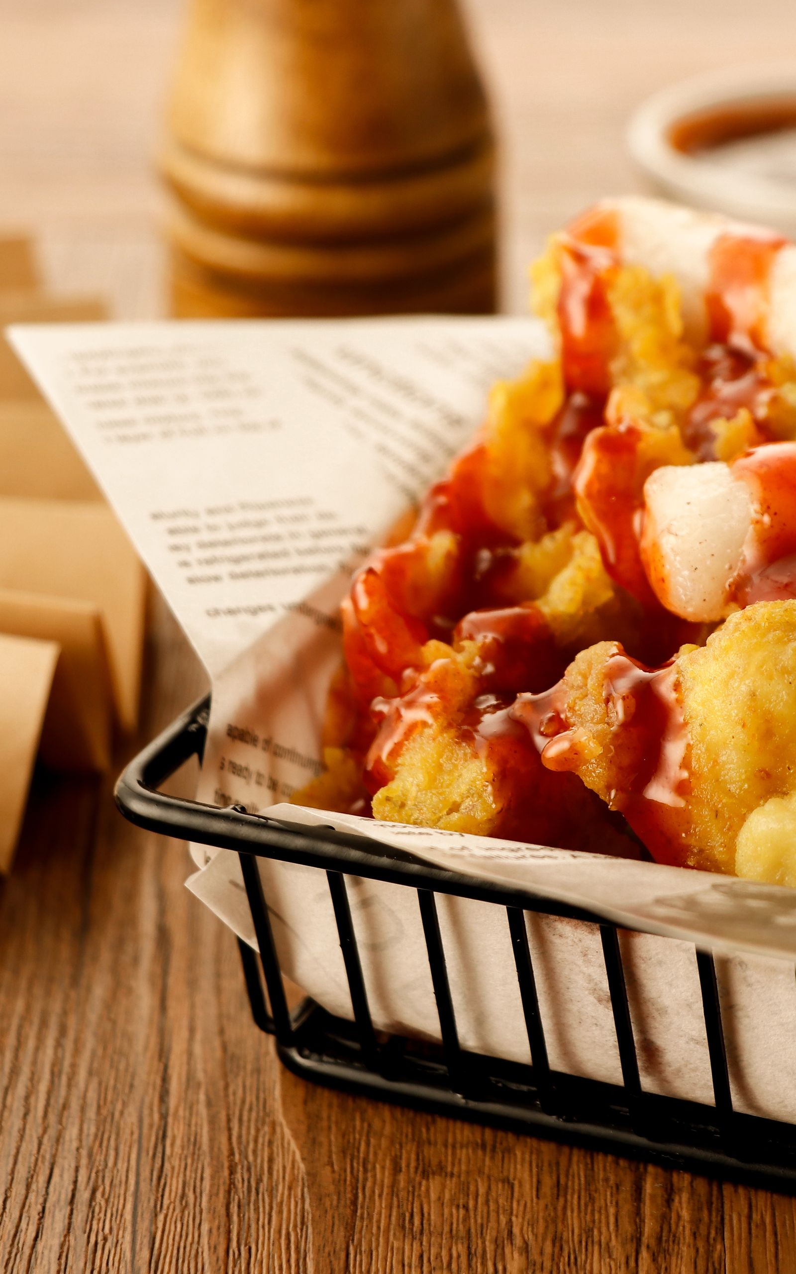 loaded fries with sauce in a serving basket.