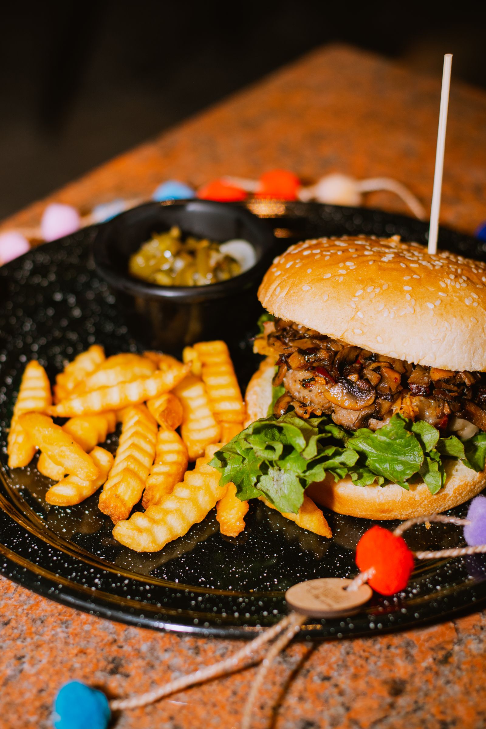 a burger and fries on a dark casual table.
